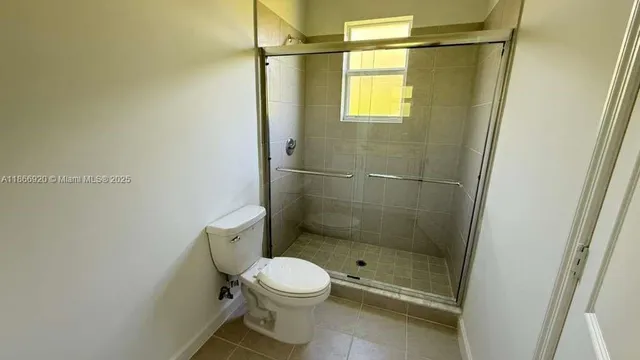 a bathroom with a shower and a toilet