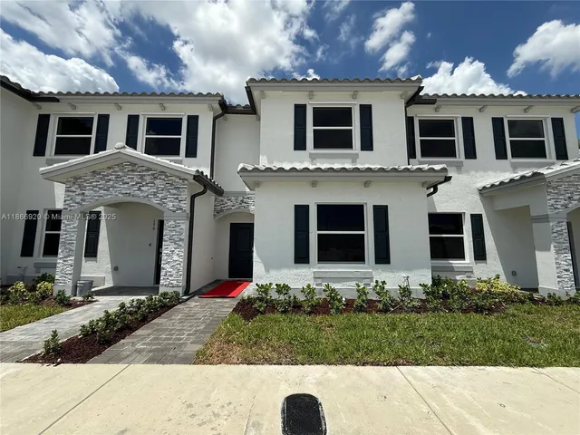 a front view of a house with yard