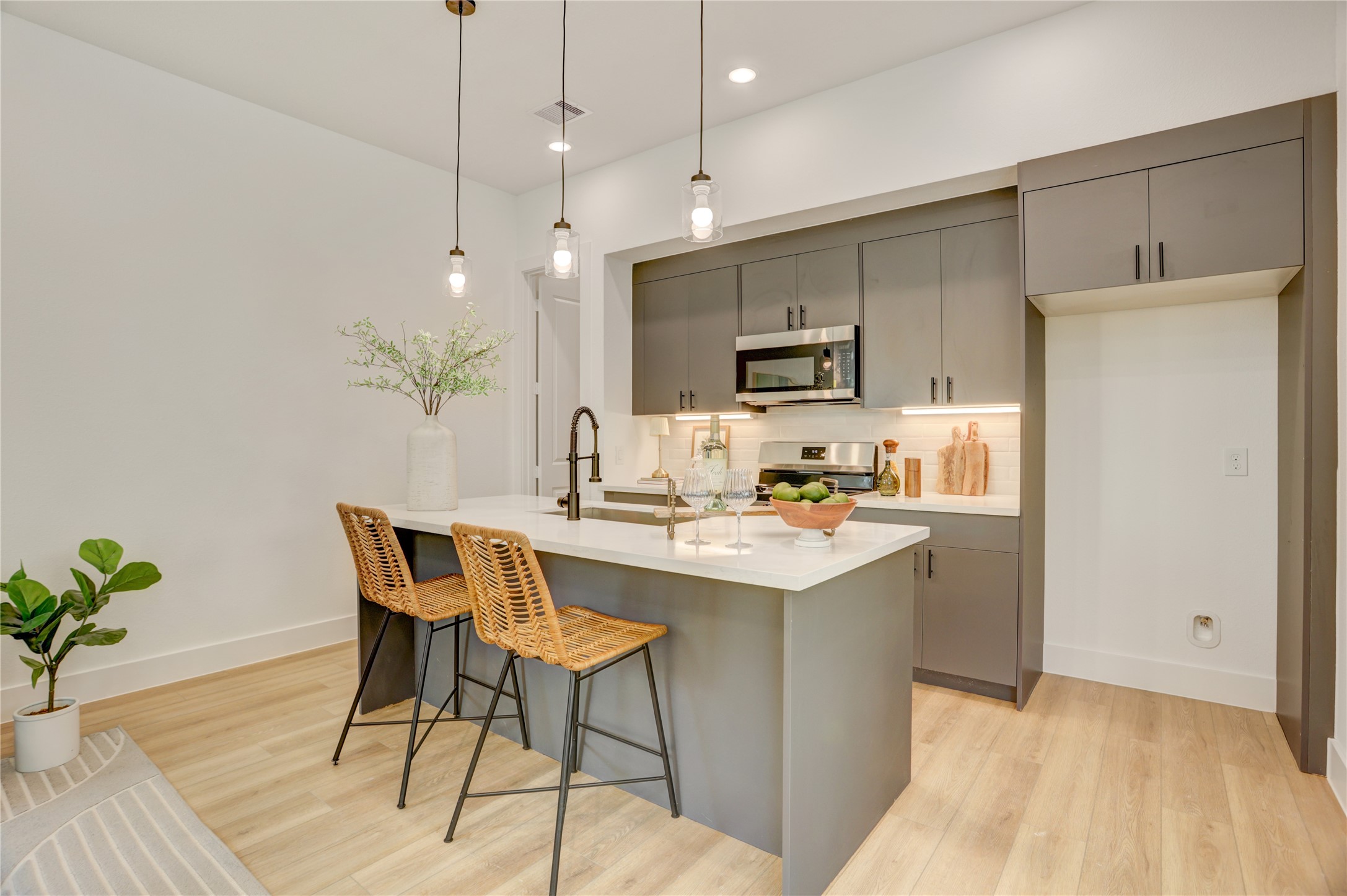 9604 Burden Street Houston, TX 77093 - Photo 12 of 28 The kitchen has a 5 burner gas stove, under cabinet lighting, and stone tile backsplash.