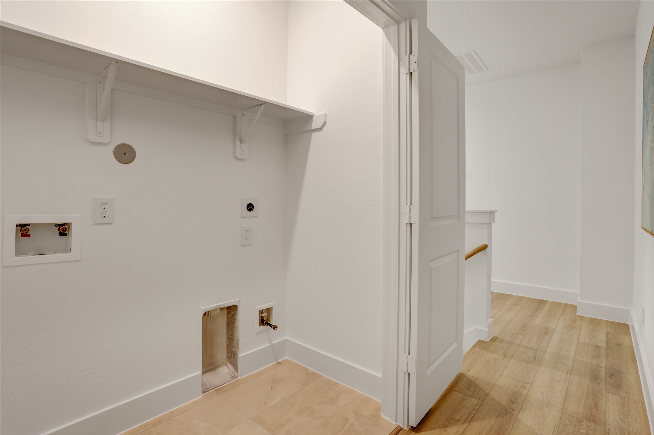 9604 Burden Street Houston, TX 77093 - Photo 18 of 28 The 3x6 SF utility room has tile floor and built in shelf.