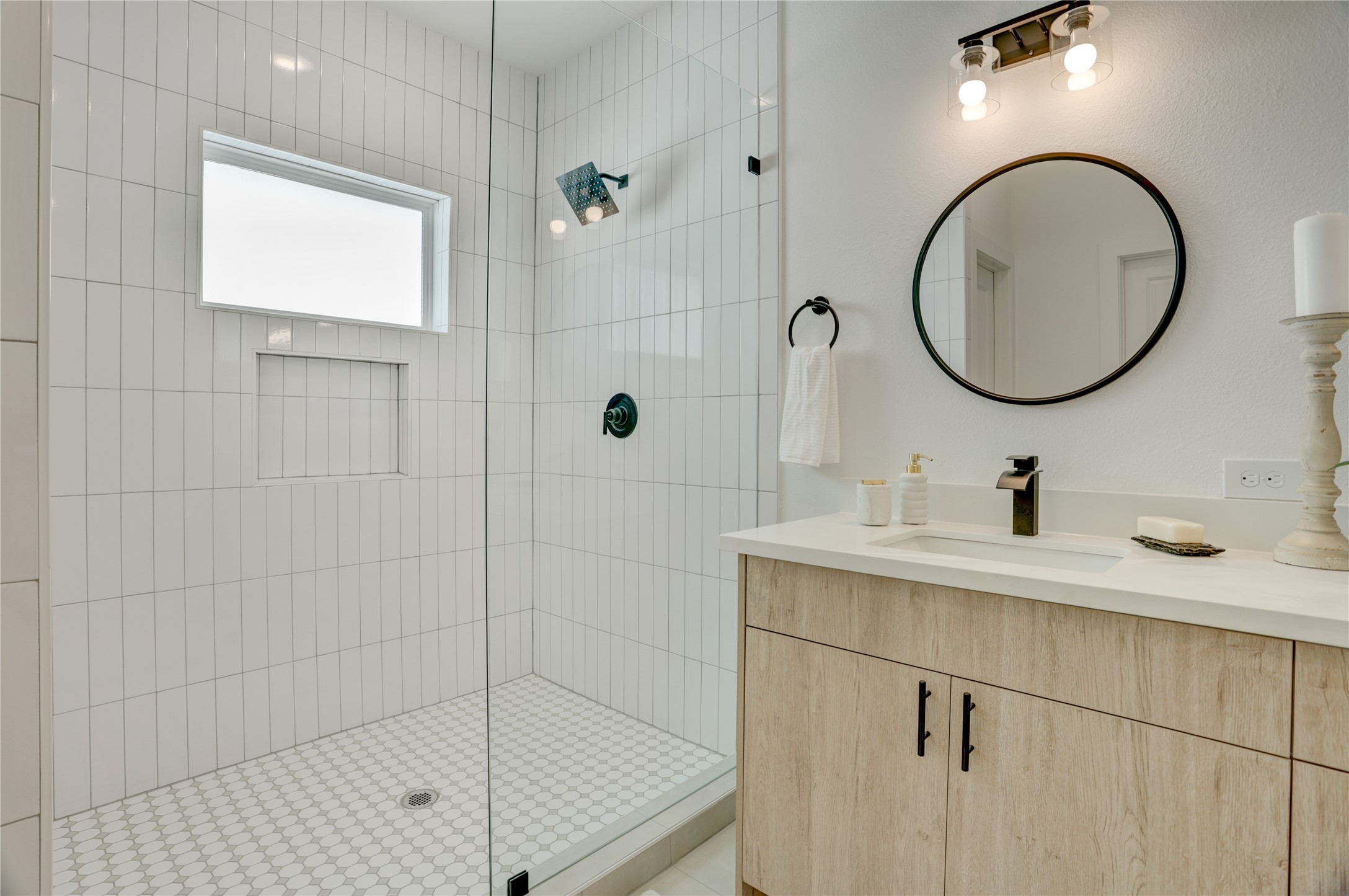 9604 Burden Street Houston, TX 77093 - Photo 20 of 28 The primary bath has a frameless standing shower with subway tile surround.