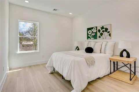 a bedroom with a bed and a table in it