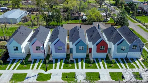 a view of multiple houses with a yard