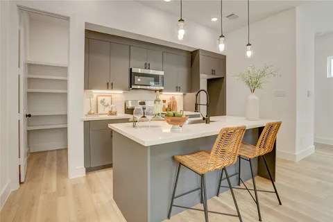 a kitchen with kitchen island a sink stainless steel appliances and cabinets
