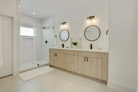 a bathroom with a double vanity sink and a mirror