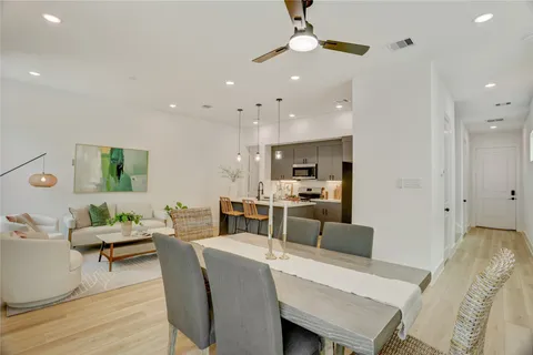 a view of a dining room with furniture and wooden floor