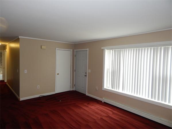 19 Wrentham Road Worcester, MA 01602 - Photo 5 of 12 a view of an empty room with wooden floor and a window