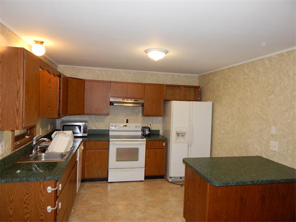 19 Wrentham Road Worcester, MA 01602 - Photo 6 of 12 a kitchen with stainless steel appliances granite countertop a sink stove and refrigerator