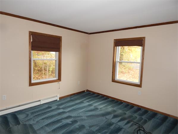 19 Wrentham Road Worcester, MA 01602 - Photo 7 of 12 a view of an empty room with wooden floor and a window