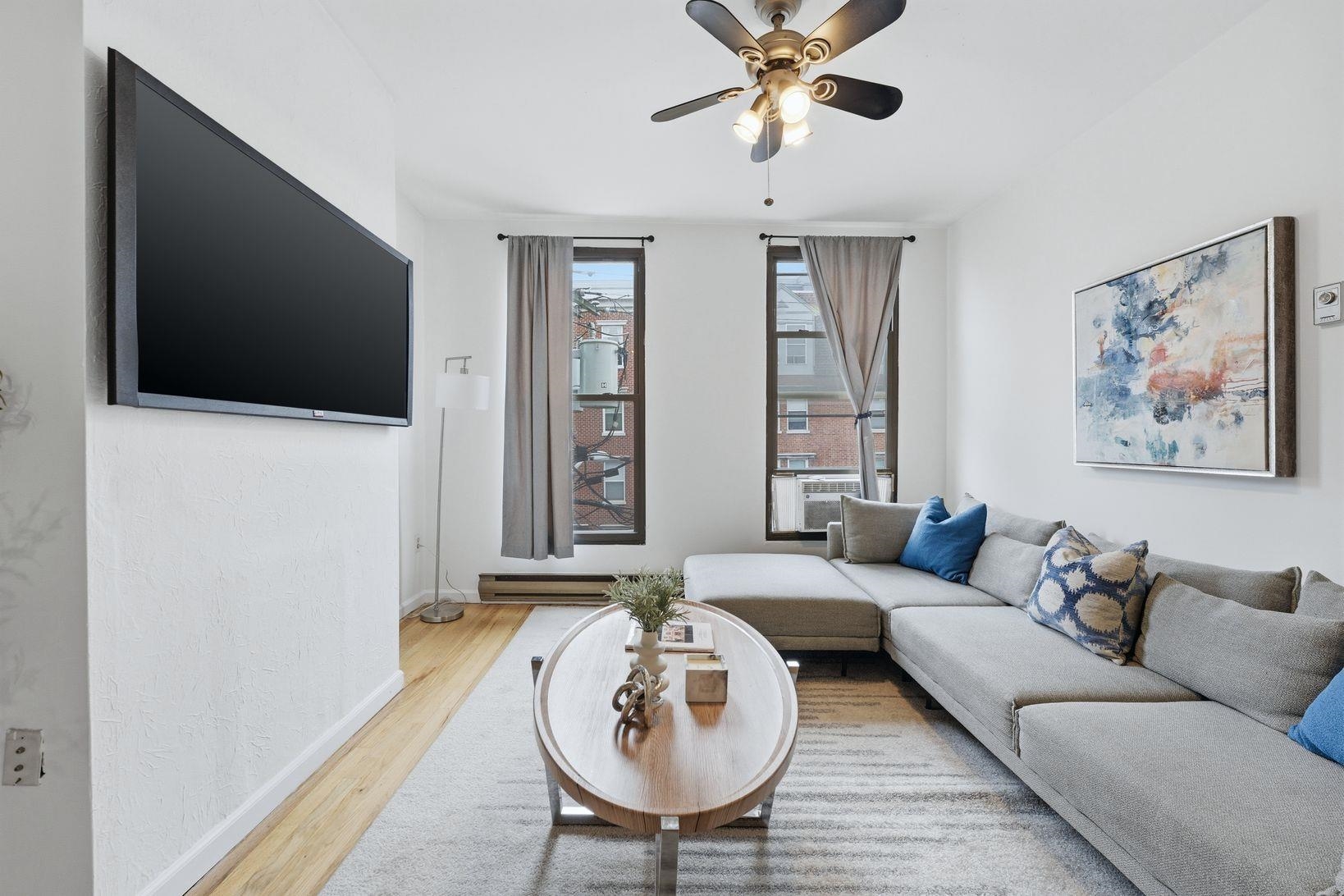 509 Monroe Street, Unit 3L Hoboken, NJ 07030 - Photo 1 of 18 a living room with furniture and a flat screen tv