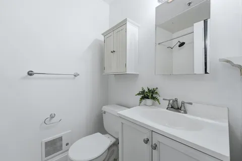 a bathroom with a sink toilet and vanity