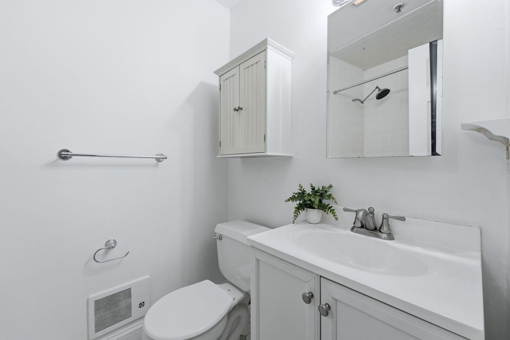 509 Monroe Street, Unit 3L Hoboken, NJ 07030 - Photo 12 of 18 a bathroom with a sink toilet and vanity