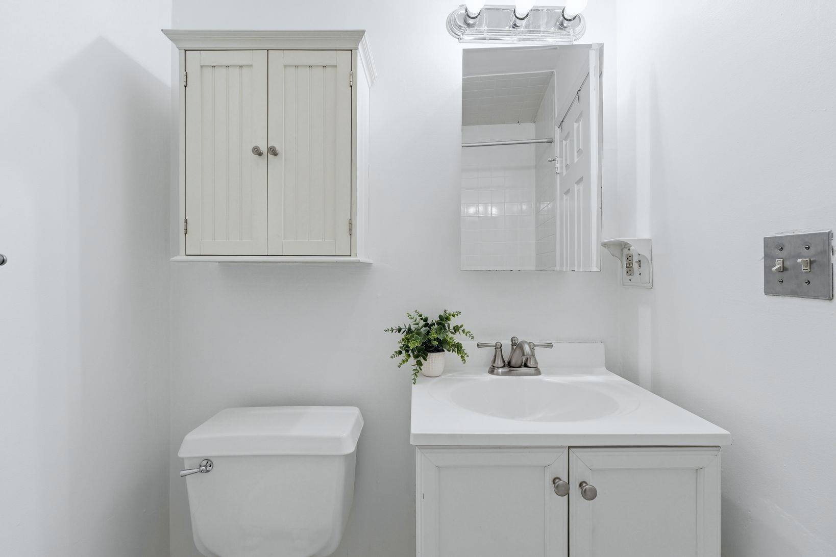 509 Monroe Street, Unit 3L Hoboken, NJ 07030 - Photo 13 of 18 a bathroom with a sink a toilet and a mirror