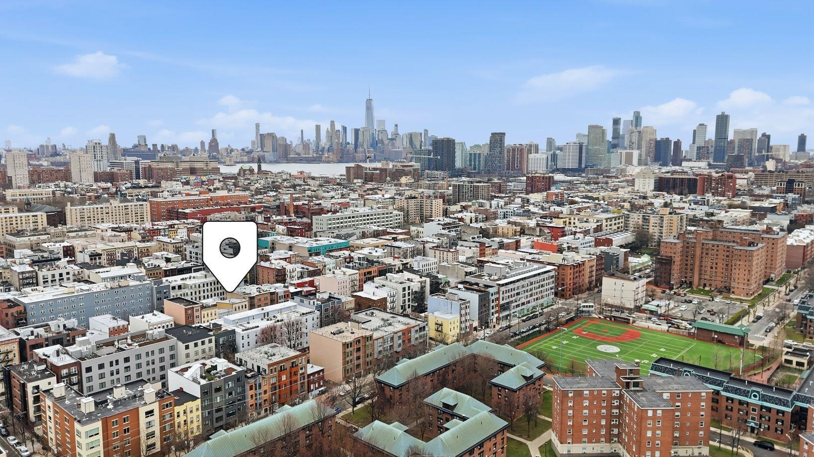 509 Monroe Street, Unit 3L Hoboken, NJ 07030 - Photo 17 of 18 a view of a city with tall buildings