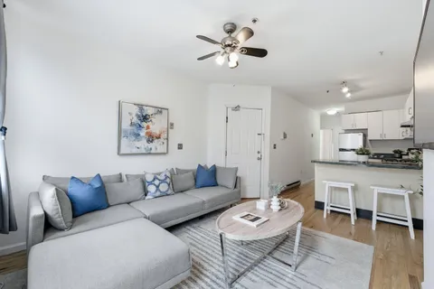 a living room with furniture a view and a chandelier