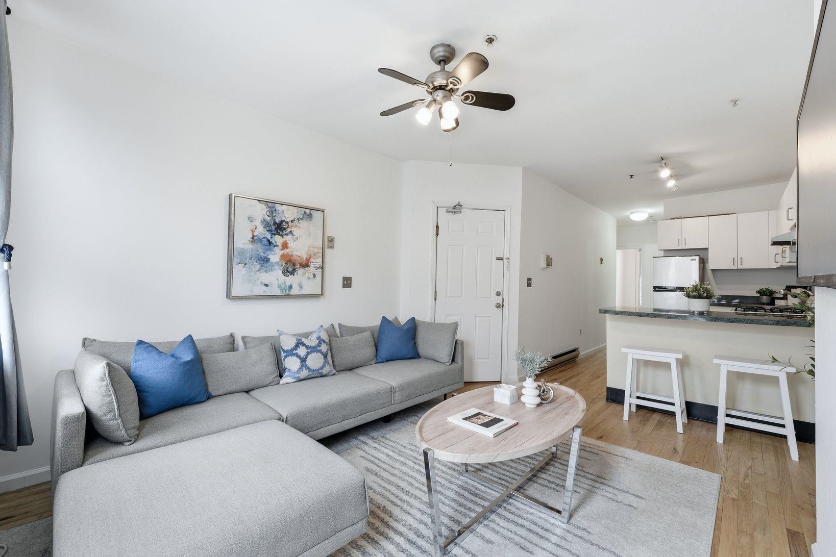 509 Monroe Street, Unit 3L Hoboken, NJ 07030 - Photo 5 of 18 a living room with furniture a view and a chandelier