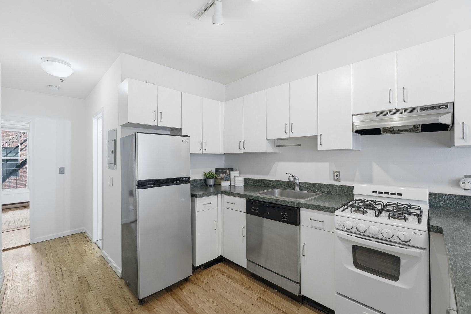 509 Monroe Street, Unit 3L Hoboken, NJ 07030 - Photo 7 of 18 a kitchen with a stove a refrigerator and a sink