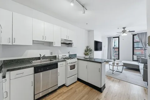 a kitchen with a sink stove and cabinets