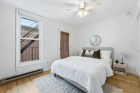 a bedroom with a bed and a window