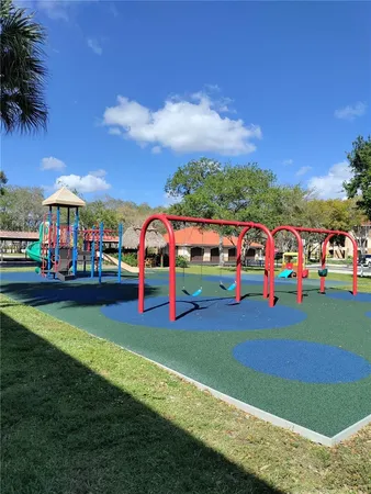 a childrens park with lots of swings and slides