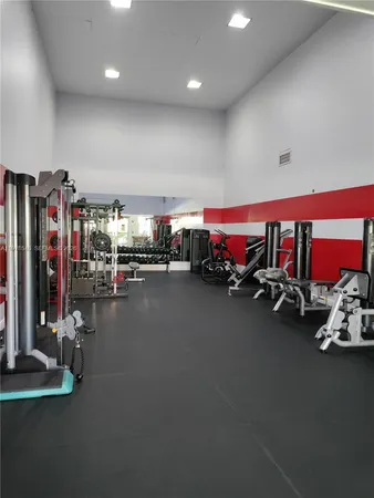 a room with gym equipment and a large window