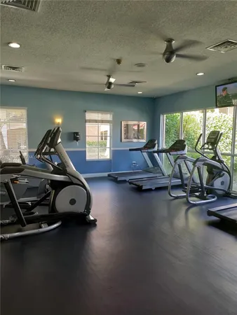 a room with gym equipment and a large window