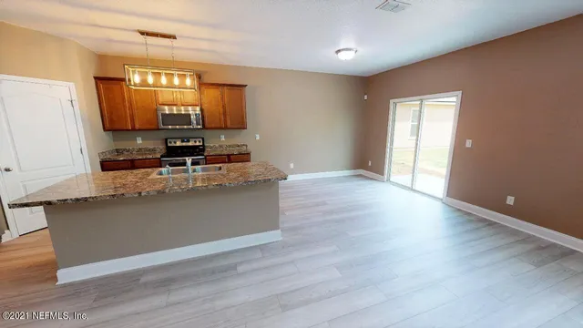 a view of a kitchen with a sink and a window