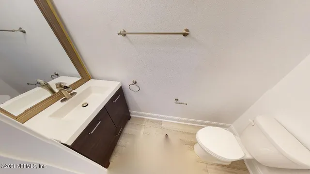 a bathroom with a sink mirror vanity and toilet