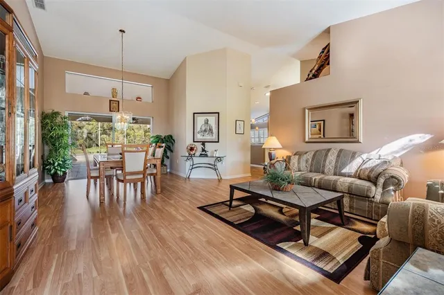 a living room with furniture a table and wooden floor