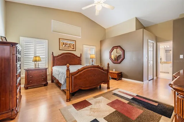 a bedroom with a bed and a lamp on a dresser