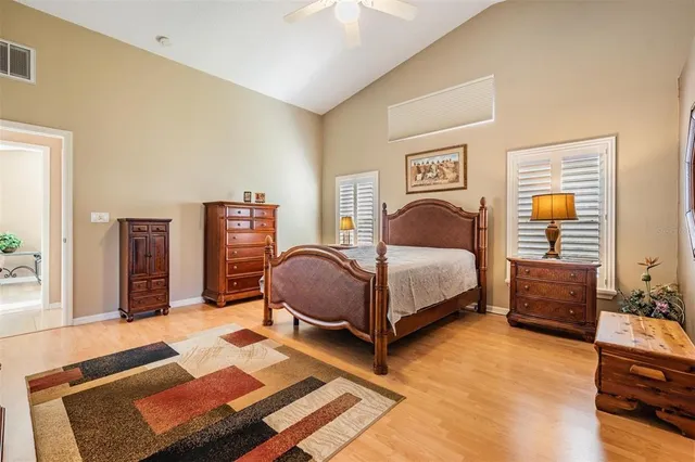 a bedroom with a bed couch and a window