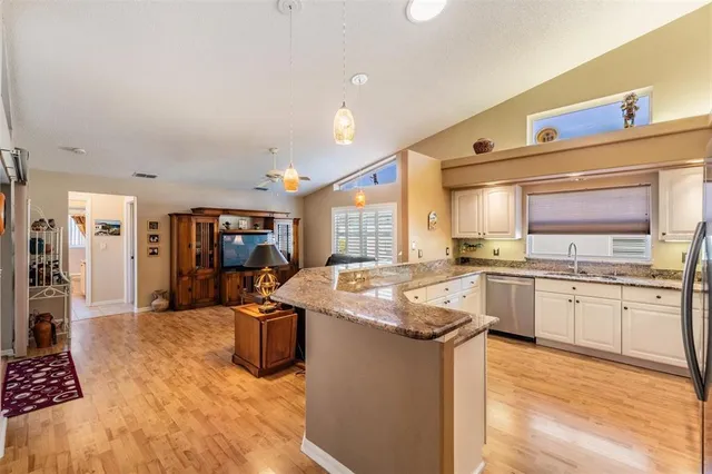 a kitchen with stainless steel appliances granite countertop a sink and cabinets