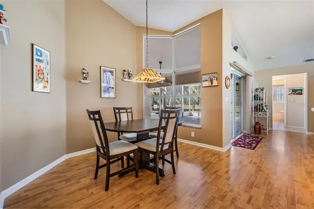 a dining room with furniture and wooden floor