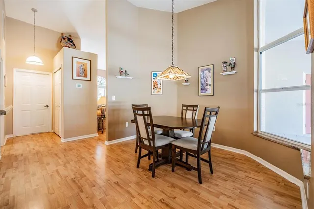 a view of a dining room with furniture wooden floor and a chandelier
