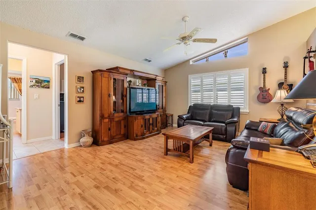a living room with furniture a window and a flat screen tv