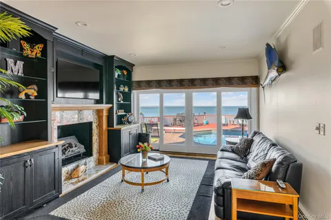 a dining room with furniture a chandelier and wooden floor