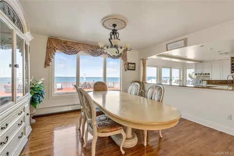 a kitchen with granite countertop stainless steel appliances sink stove and cabinets