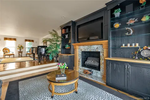 a dining room with furniture a chandelier and wooden floor