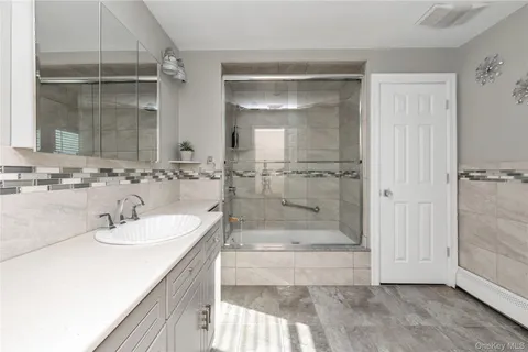 a view of a house with swimming pool and sitting area