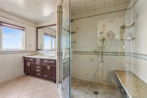 a bathroom with a granite countertop sink mirror and shower