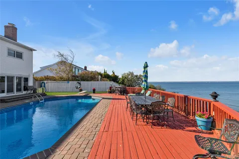 a view of a yard with swimming pool and seating space