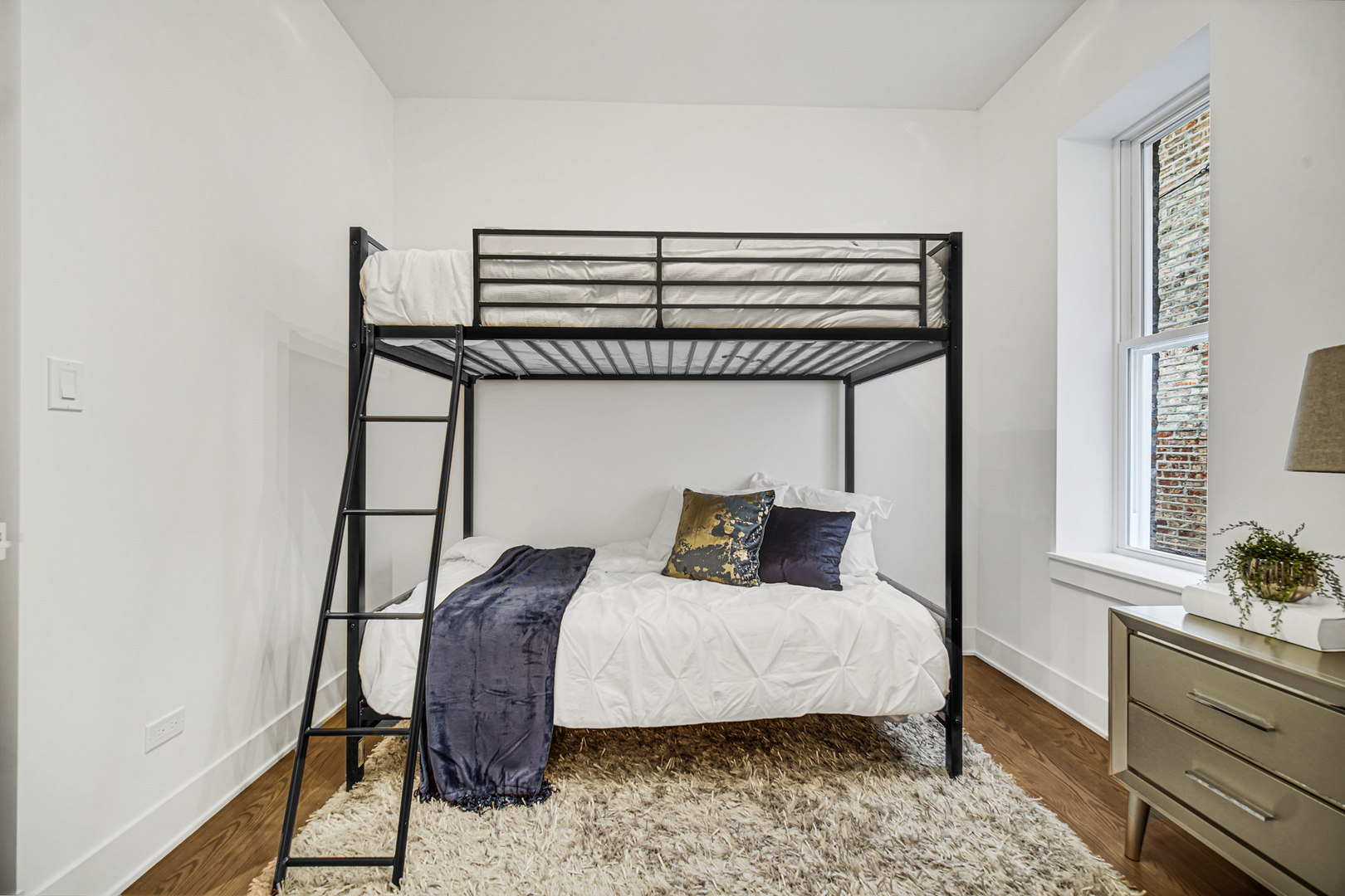 4559 South Michigan Avenue, Unit 2S Chicago, IL 60653 - Photo 14 of 26 a bedroom with a bed and wooden floor