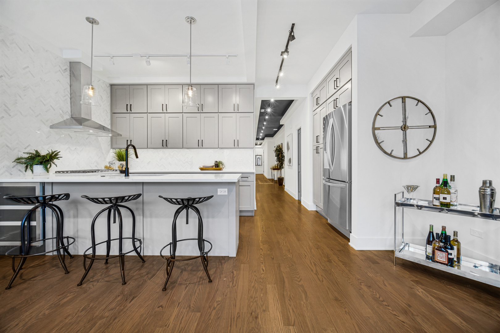 4559 South Michigan Avenue, Unit 2S Chicago, IL 60653 - Photo 16 of 26 a open kitchen with stainless steel appliances granite countertop a table chairs in it and wooden floors