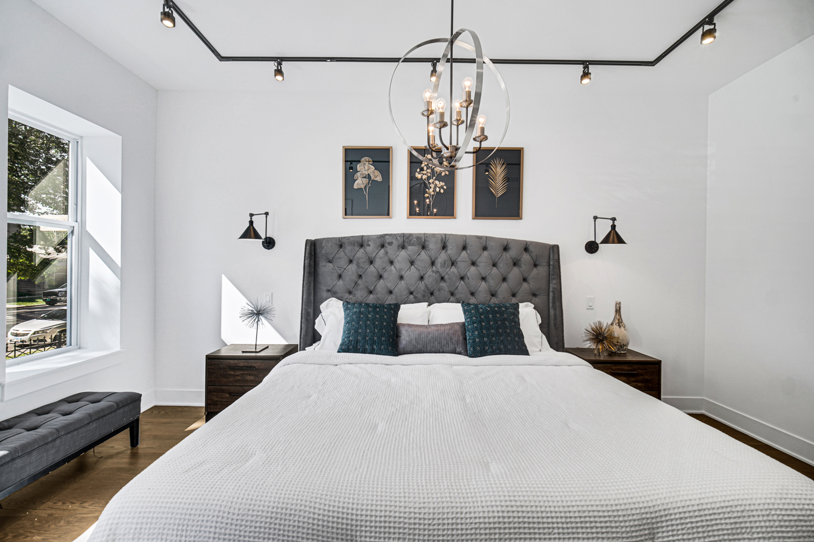 4559 South Michigan Avenue, Unit 2S Chicago, IL 60653 - Photo 6 of 26 a bedroom with a bed and a chandelier