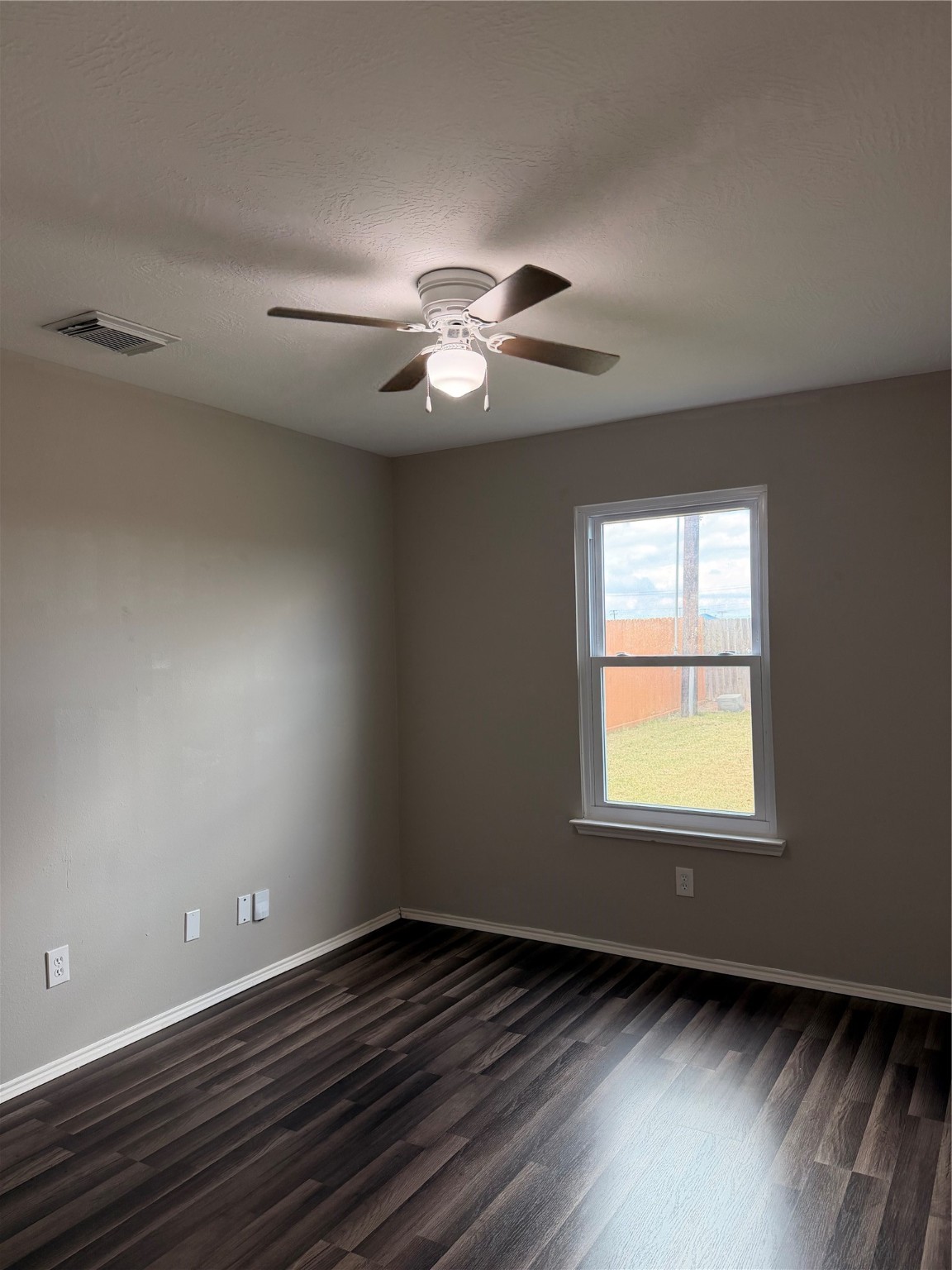 4707 East Parma Drive Rosenberg, TX 77471 - Photo 13 of 24 a view of an empty room with wooden floor and a window