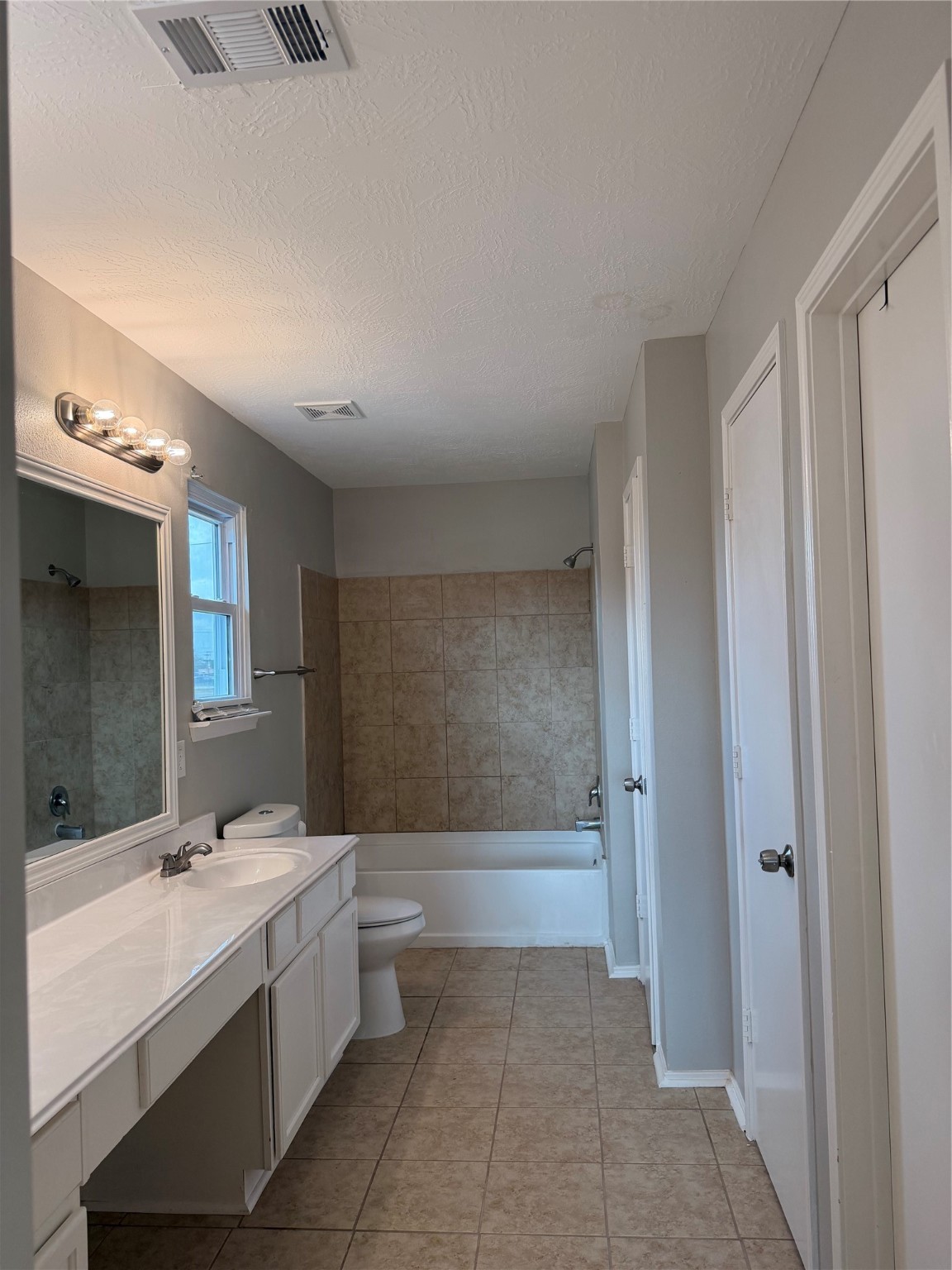 4707 East Parma Drive Rosenberg, TX 77471 - Photo 19 of 24 a bathroom with a double vanity sink a toilet and a mirror