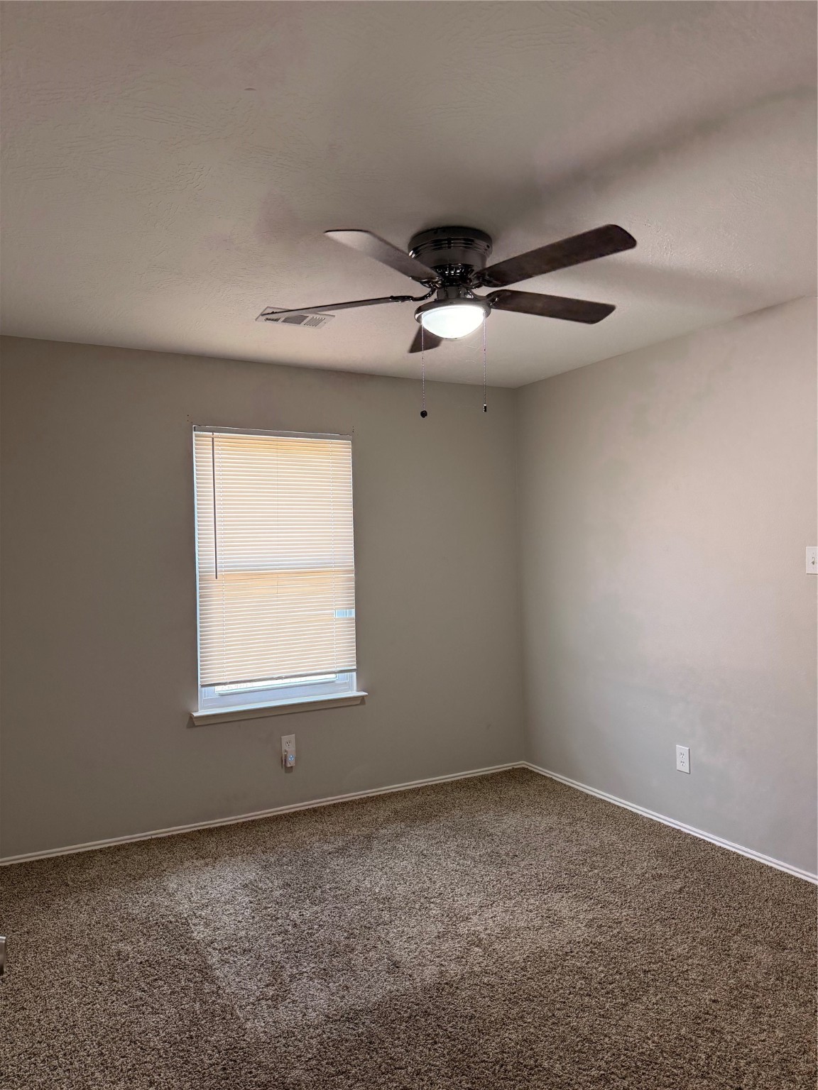 4707 East Parma Drive Rosenberg, TX 77471 - Photo 23 of 24 an empty room with a ceiling fan and window
