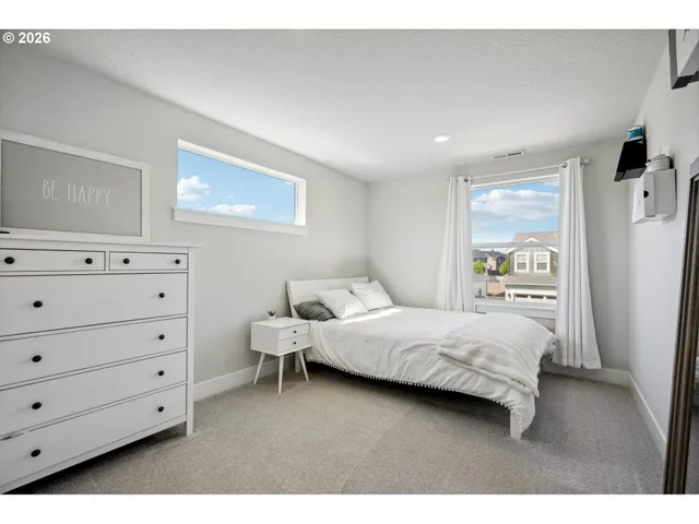 a bedroom with a bed and cabinets