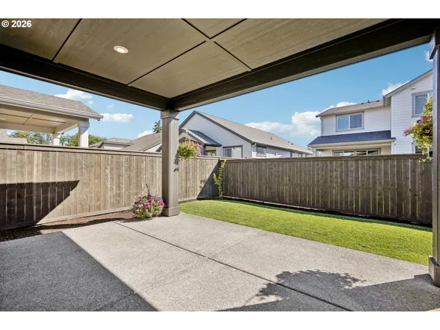 a view of a backyard with garden and flowers