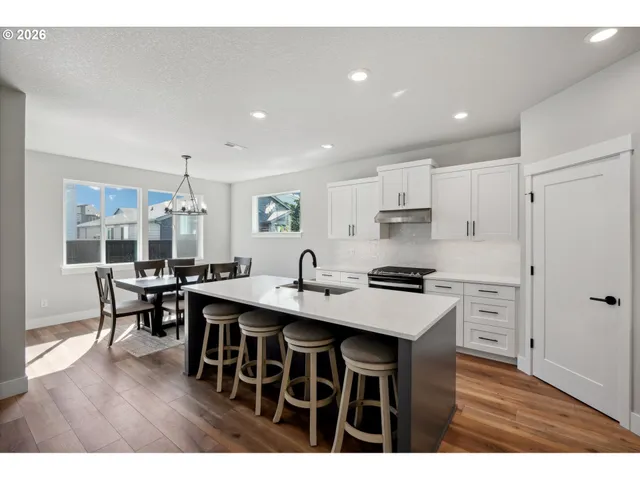 a kitchen with kitchen island a sink stainless steel appliances and cabinets